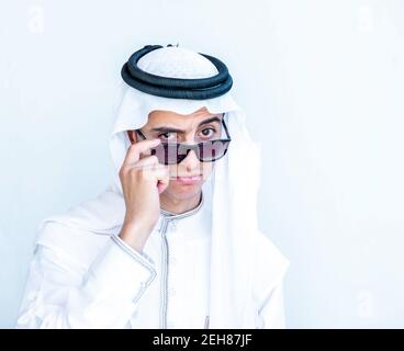 Arabic young man wearing sunglasses and peeking Stock Photo