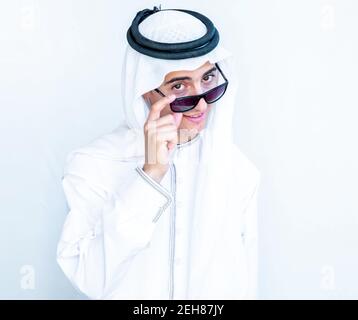 Arabic young man wearing sunglasses and peeking Stock Photo