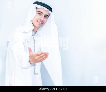 Arabic young man welcoming other people Stock Photo