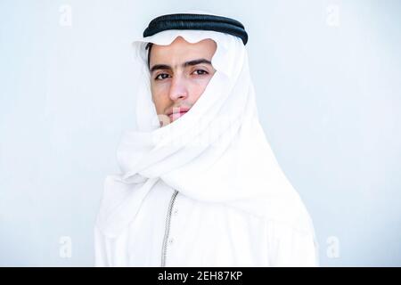 Arabic young man masking his face with hatta Stock Photo