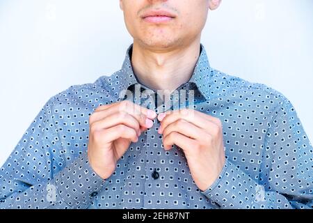 Young arabic guy doing his buttons Stock Photo