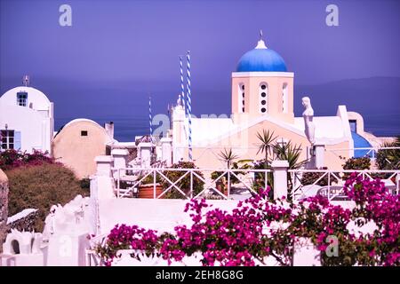 Santorini, Greece - September 11, 2017: Typical church in santorini island with blue roof top against seascape in the famous town of oia Stock Photo