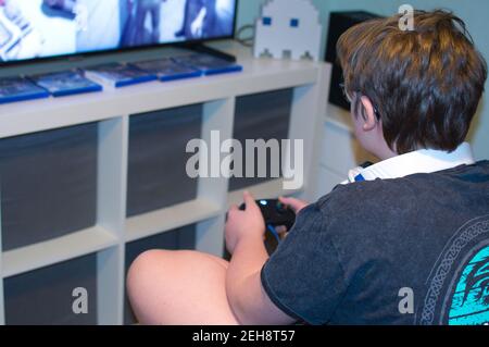Teenage boy playing new Xbox console. Stock Photo