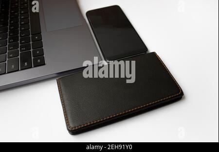 laptop notepad and smartphone lie on a white background. Top view, flat lay. Copy space.  Stock Photo