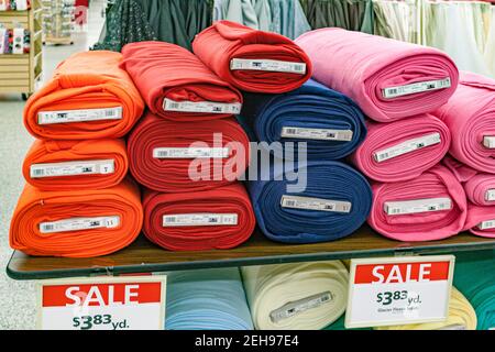 Colorful bolts of fleece fabric on sale in a retail store. Stock Photo