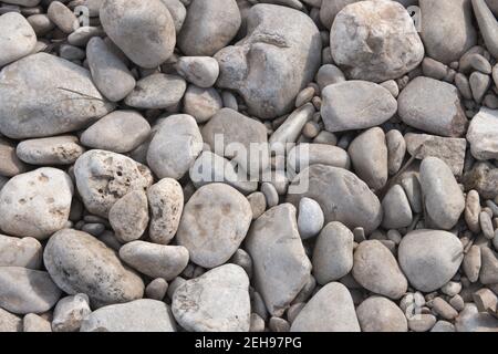 Image of some gray stones on the bank of a riverbed that can serve as a background cone copy space Stock Photo