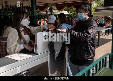 Visitors wearing face masks as a precaution against the spread of coronavirus, entering during the reopening of Hong Kong Disneyland Park as government loosens coronavirus (Covid-19) social-distancing measures. Stock Photo