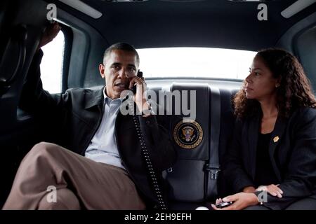 President Barack Obama, with Chief of Staff for Policy Mona Sutphen, talks on the phone with California Gov. Arnold Schwarzenegger, while in the motorcade during a trip to Richmond, Va., Sept. 29, 2010. Stock Photo