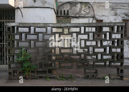 A concrete fence with ornament next to a residential building in Bucharest, Romania Stock Photo