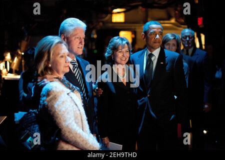 President Barack Obama, along with Secretary of State Hillary Rodham Clinton, former President Bill Clinton, and Richard Holbrooke’s widow, Kati Marton, watch from backstage as a slide show of pictures are displayed during a funeral service for Holbrooke at the John F. Kennedy Center for the Performing Arts in Washington, D.C., Jan. 14, 2011. Stock Photo