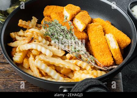 Fish fingers and Chips british fast food with tartar sauce set, on frying iron pan Stock Photo