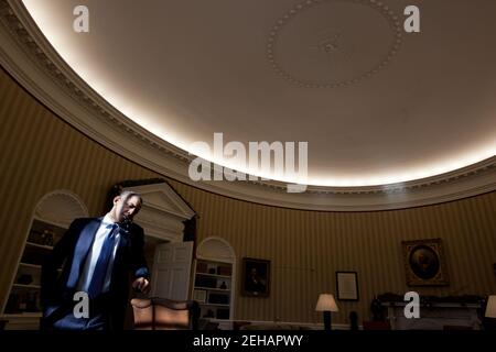 President Barack Obama talks on the phone in the Oval Office, Dec. 19, 2011. Stock Photo