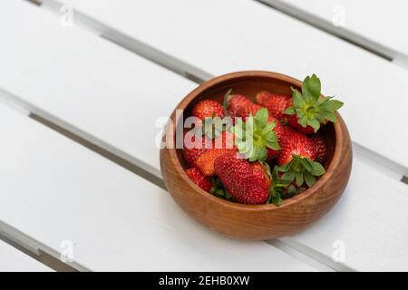 Bowl of Red, Ripe Strawberries Fresh From the Garden on White Wood Table Stock Photo