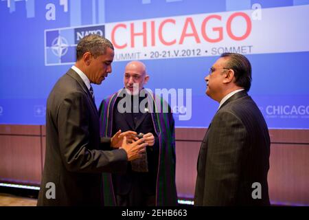 President Barack Obama speaks with President Hamid Karzai of Afghanistan, center, and President Asif Ali Zardari of Pakistan at the McCormick Place Convention Center during the NATO Summit in Chicago, Illinois, May 21, 2012. Stock Photo