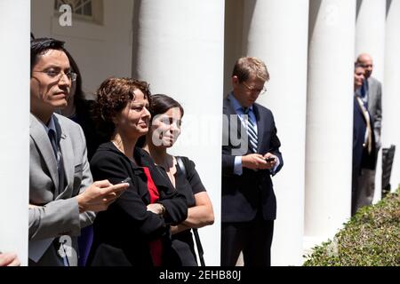 White House staff members listen from the Colonnade of the White House as President Barack Obama delivers remarks on the Department of Homeland Security’s immigration announcement in the Rose Garden, June 15, 2012. Pictured, from left, are: Luis Miranda, Director of Hispanic Media; Cecilia Muñoz, Director of the Domestic Policy Council; Miriam Calderon, a detailee to the Domestic Policy Council from the Department of Health and Human Services; and Press Secretary Jay Carney. Stock Photo