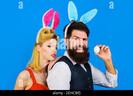 Easter couple. Happy family celebrate Easters. Handsome bearded man and funny woman. Bunny ears. Love. Stock Photo