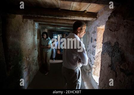 President Barack Obama looks out a cell window as he and First Lady Michelle Obama tour the Maison des Esclaves Museum on Gorée Island, Senegal, June 27, 2013. Stock Photo