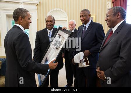 President Barack Obama greets members of the 1963 Loyola University Chicago Ramblers NCAA Championship men's basketball team in the Oval Office, July 11, 2013. Stock Photo