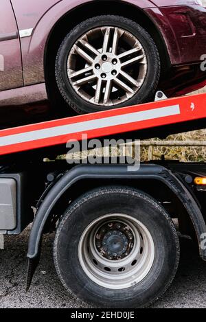 Side view of tow truck with car after breakdown on the highway Stock Photo