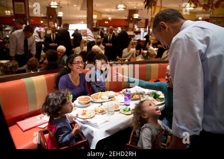 Oct. 25, 2013 'A young girl captures the President's attention as he greeted customers at Junior's Cheesecake with New York City mayoral candidate Bill de Blasio in Brooklyn.' Stock Photo