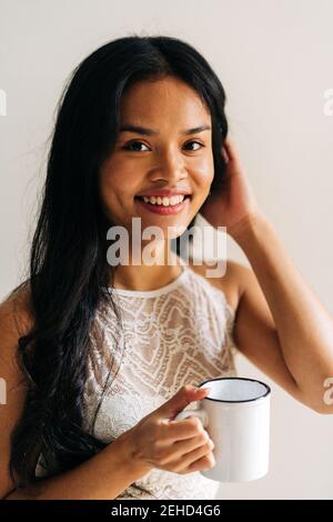 Portrait of asian Woman holding a cup of coffee Stock Photo