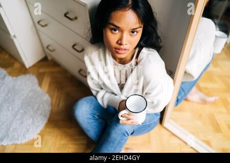 Portrait of asian Woman holding a cup of coffee Stock Photo