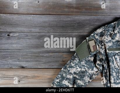 Military uniform jacket with US flag patch on rustic wood Stock Photo