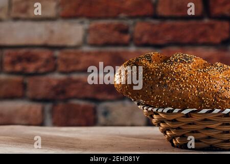 Side view of tasty cut bread with brown crust and crunchy sunflower seeds on top in wicker basket Stock Photo
