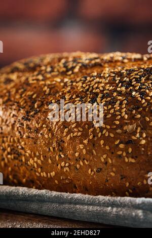 Closeup of tasty cut bread with brown crust and crunchy sunflower seeds on top in wicker basket Stock Photo