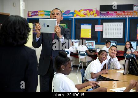 President Barack Obama records a video on an iPad during a classroom visit with students at Buck Lodge Middle School in Adelphi, Md., Feb. 4, 2014. Stock Photo