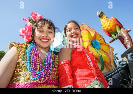 Miami Florida,Bayfront Park Greater Miami Mardi Gras Festival,Haitian Hispanic Caribbean girl girls friends wearing costumes beads float,riding, Stock Photo