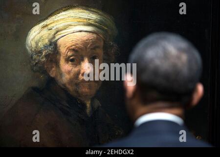 President Barack Obama looks at Rembrandt's 'Self-portrait as the Apostle Paul' as he tours the Rijksmuseum in Amsterdam, the Netherlands, March 24, 2014. Stock Photo