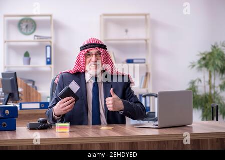 Old arab businessman working in the office Stock Photo