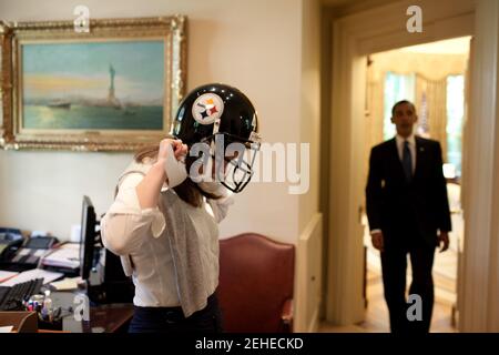 President Barack Obama's personal secretary, Katie Johnson, tries on a Pittsburgh Steelers football helmet outside the Oval Office, May 21, 2009.
