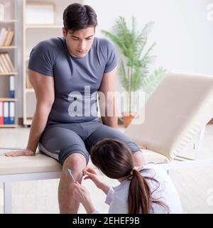 The doctor checking patients joint flexibility with gonimeter Stock Photo