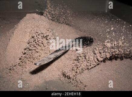 Cocoa splash with a spoon, studio shot Stock Photo