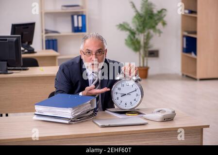 Senior businessman employee in time management concept Stock Photo