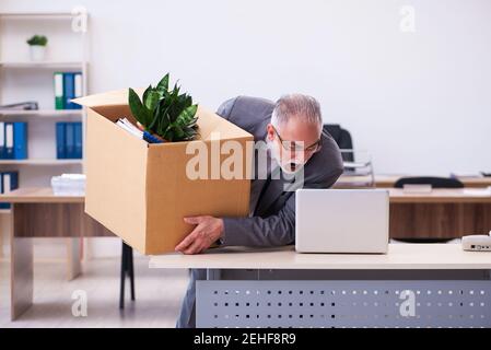 Old employee being fired from his work Stock Photo