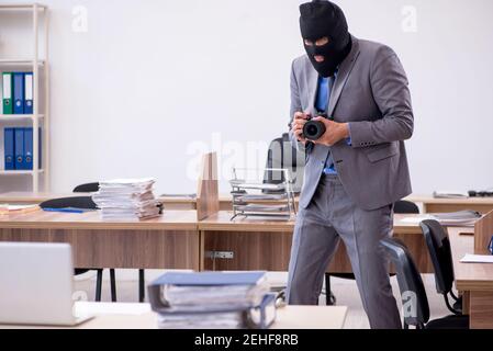 Young employee in industrial espionage concept Stock Photo