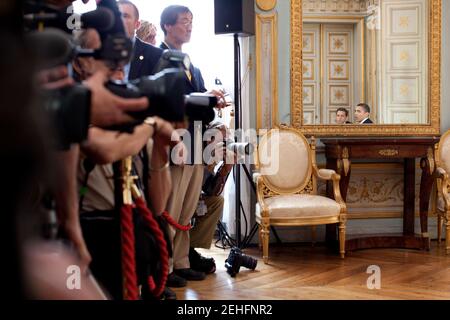 Members of the press watch as President Barack Obama meets with French President Nicolas Sarkozy during a bilateral meeting in Caen, France, June 6, 2009. Stock Photo
