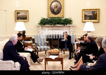President Barack Obama listens to Interior Secretary Ken Salazar during an Oval Office meeting on the regulation of mountaintop mining, June 9, 2009. From left, Terrence 'Rock' Salt, acting Assistant Secretary of the Army for Civil Works; Lisa Jackson, EPA Administrator; the President; Nancy Sutley, Chair of the Council on Environmental Quality; Sec. Salazar; and Carol Browner, Assistant to the President for Energy and Climate Change. Stock Photo