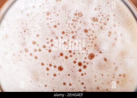 Light Beer with Bubbles and Foam Background. Beer Bubbles Texture Close Up. Stock Photo