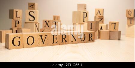 The word governor is from wooden cubes. Economy state government terms. Background made of wooden letters. Stock Photo