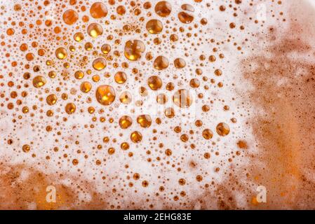 Light Beer with Bubbles and Foam Background. Beer Bubbles Texture Close Up. Stock Photo