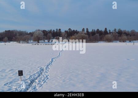 Life in a cold city - winterscapes from Ottawa - ad hoc shortcut across a frozen Dow's Lake to get to the Arboretum. Ontario, Canada. Stock Photo