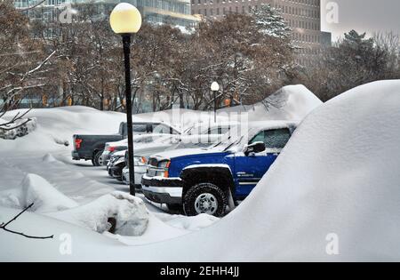 Life in a cold city - winterscapes from Ottawa - cars in the parking lot at Dow's Lake obscured by mounds of plowed snow. Ontario, Canada. Stock Photo