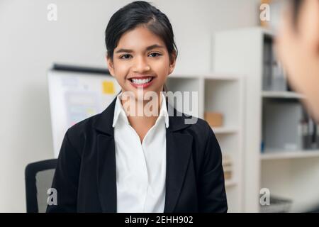Attractive Asian businesswoman meeting and talking to brainstorm about teamwork planning on a table with laptop in the office Stock Photo