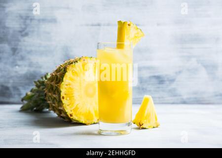 Fresh pineapple beverage on rustic background. Selective focus. Shallow depth of field. Stock Photo
