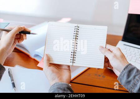 High school or college students  group catching up workbook and learning tutoring on desk and reading, doing homework, lesson practice preparing exam. Stock Photo