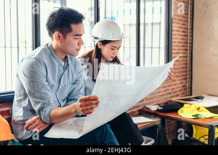 industry manager and engineer, businessman reading and checking blueprint, drawing  in the room Stock Photo